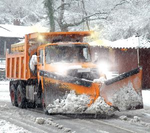 Snow Plow Orange snow plow in action with LED rectangular headlight