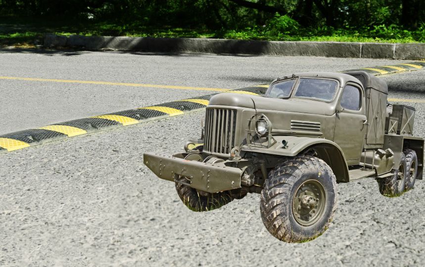 A military vehicle next to a speed bump