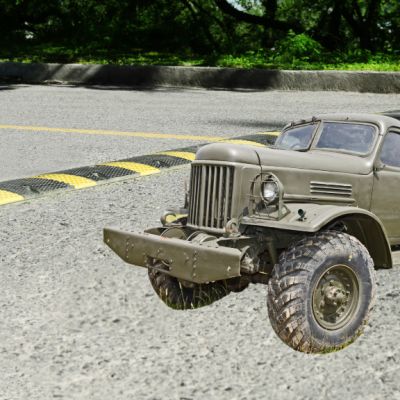 A military vehicle next to a speed bump