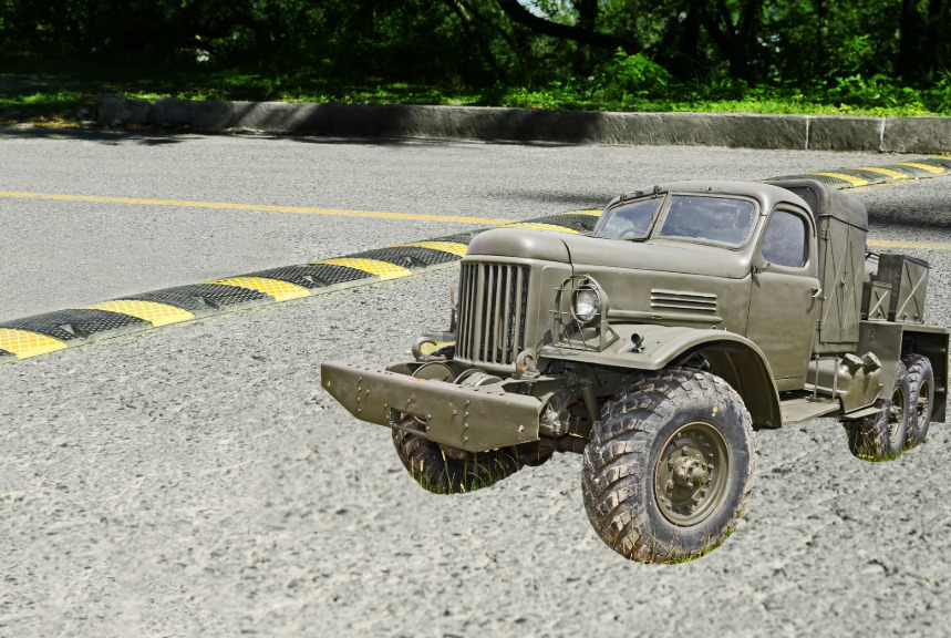 light-flicker-on-speed-bump A military vehicle next to a speed bump